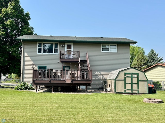 1922 13th Ave N, Moorhead, MN 56560 - rear view of property featuring a storage shed, a wooden deck, stairway, and a fire pit