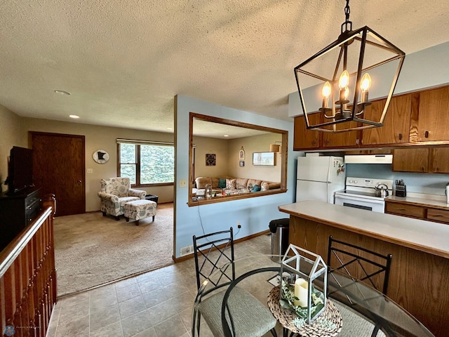 1922 13th Ave N, Moorhead, MN 56560 - kitchen featuring white appliances, light countertops, extractor fan, light carpet, and brown cabinetry