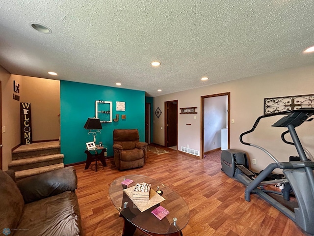 1922 13th Ave N, Moorhead, MN 56560 - living area featuring a textured ceiling, wood finished floors, recessed lighting, and stairs