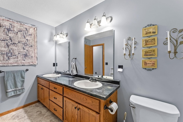 315 Roosevelt St S Unit B, Cambridge, MN 55008 - bathroom featuring double vanity, toilet, and baseboards