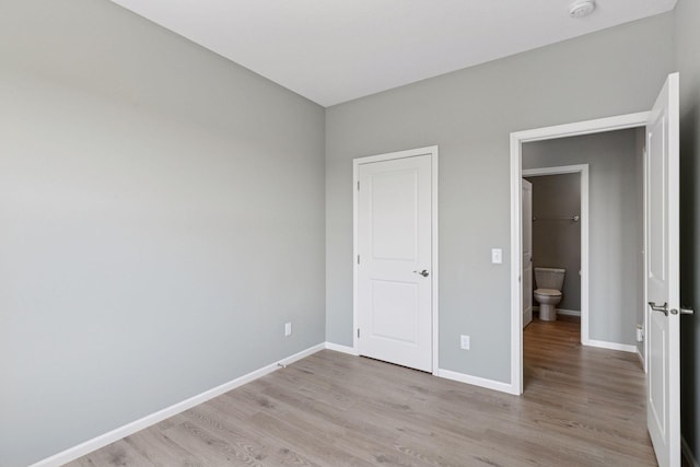 1250 Naser Way, New Richmond, WI 54017 - unfurnished bedroom featuring light wood-style floors and baseboards