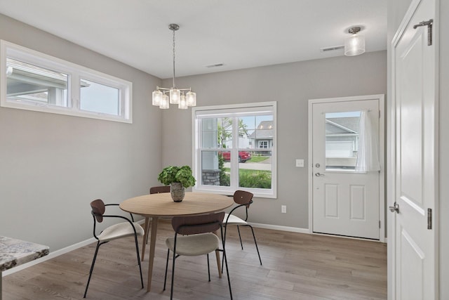 1250 Naser Way, New Richmond, WI 54017 - dining room with light wood-style flooring and a chandelier