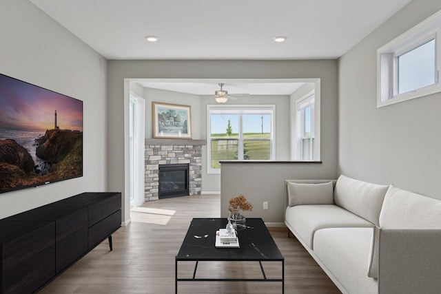 1250 Naser Way, New Richmond, WI 54017 - living room featuring plenty of natural light, a stone fireplace, ceiling fan, wood finished floors, and recessed lighting