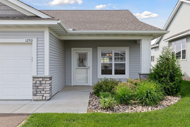 1250 Naser Way, New Richmond, WI 54017 - view of exterior entry with a shingled roof and a garage