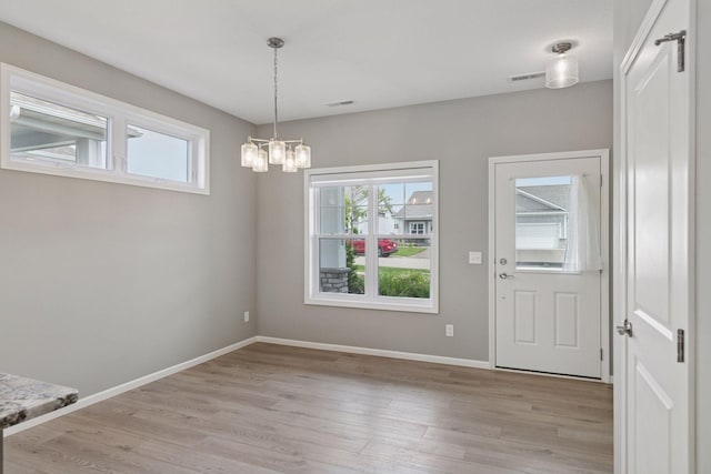 1250 Naser Way, New Richmond, WI 54017 - unfurnished dining area with a chandelier and light wood-style floors