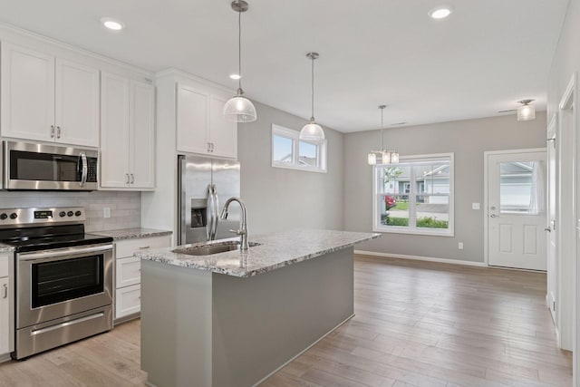1250 Naser Way, New Richmond, WI 54017 - kitchen featuring stainless steel appliances, tasteful backsplash, white cabinets, light wood finished floors, and recessed lighting