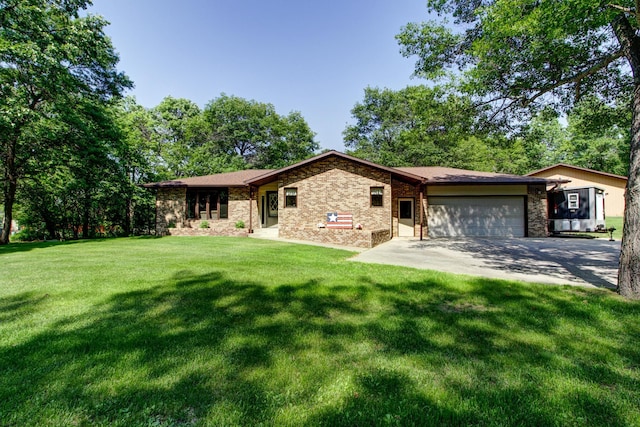 305 Birch Briar Ln, Park Rapids, MN 56470 - view of front of house with an attached garage, concrete driveway, a front lawn, and brick siding