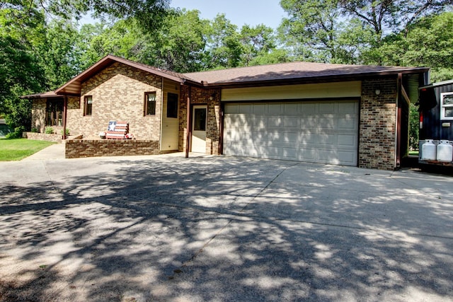 305 Birch Briar Ln, Park Rapids, MN 56470 - view of front of home with brick siding, an attached garage, and driveway