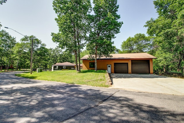 305 Birch Briar Ln, Park Rapids, MN 56470 - view of front of home featuring concrete driveway, a front yard, a garage, and a metal roof