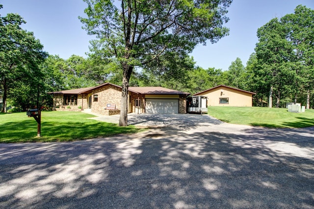 305 Birch Briar Ln, Park Rapids, MN 56470 - single story home with stone siding, asphalt driveway, an attached garage, and a front yard
