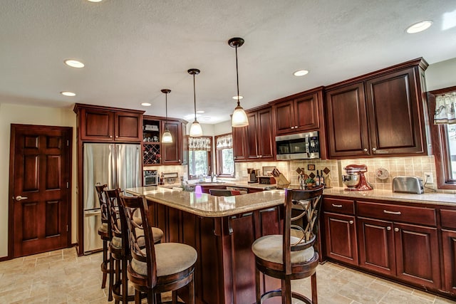 305 Birch Briar Ln, Park Rapids, MN 56470 - kitchen featuring appliances with stainless steel finishes, tasteful backsplash, recessed lighting, light stone countertops, and light stone finish floors