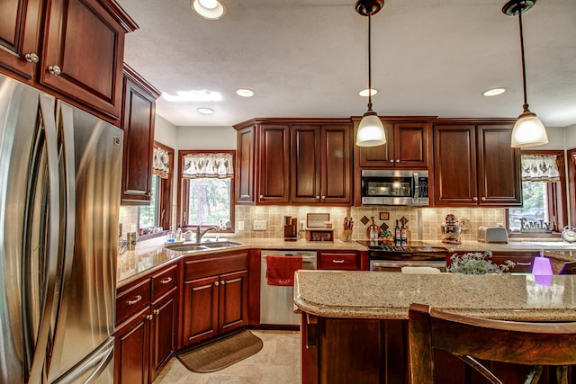 305 Birch Briar Ln, Park Rapids, MN 56470 - kitchen with stainless steel appliances, plenty of natural light, decorative backsplash, hanging light fixtures, and recessed lighting
