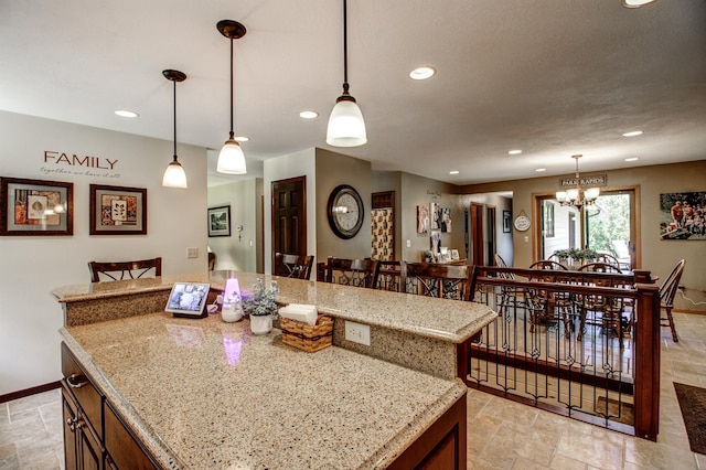305 Birch Briar Ln, Park Rapids, MN 56470 - kitchen with a chandelier, stone tile floors, recessed lighting, hanging light fixtures, and a kitchen island