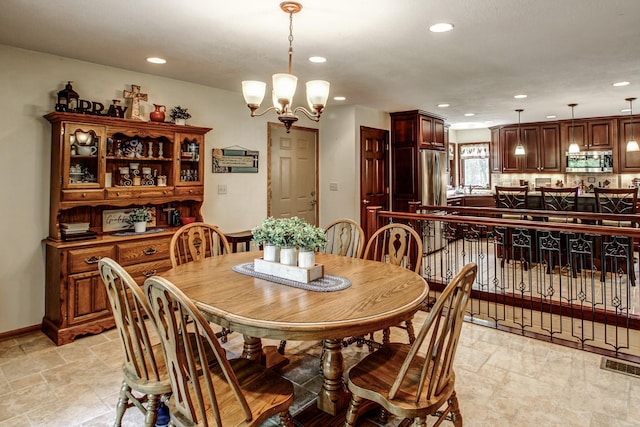 305 Birch Briar Ln, Park Rapids, MN 56470 - dining area with recessed lighting, a chandelier, and light stone finish floors