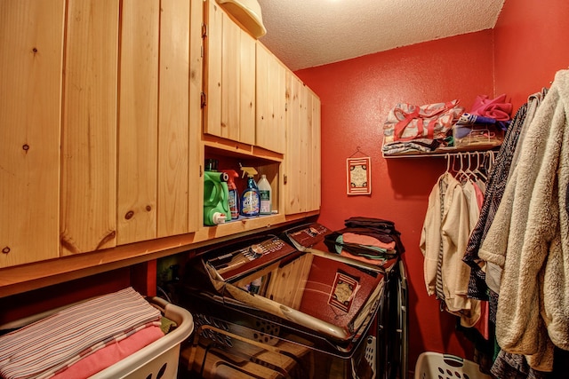 305 Birch Briar Ln, Park Rapids, MN 56470 - laundry room with separate washer and dryer, cabinet space, a textured ceiling, and a textured wall