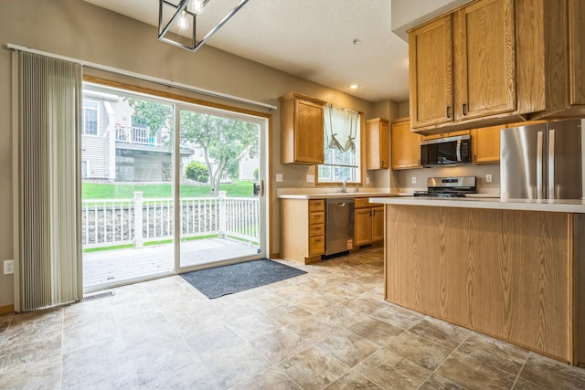8812 Brunswick Path, Inver Grove Heights, MN 55076 - kitchen with appliances with stainless steel finishes, light countertops, and brown cabinetry