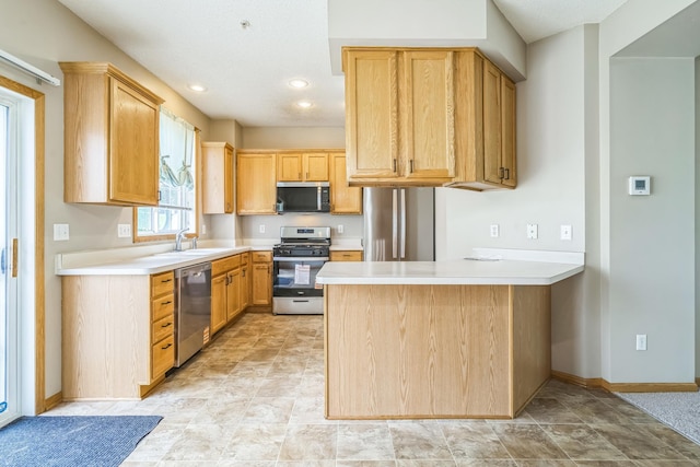 8812 Brunswick Path, Inver Grove Heights, MN 55076 - kitchen featuring appliances with stainless steel finishes, a peninsula, light countertops, recessed lighting, and stone finish flooring