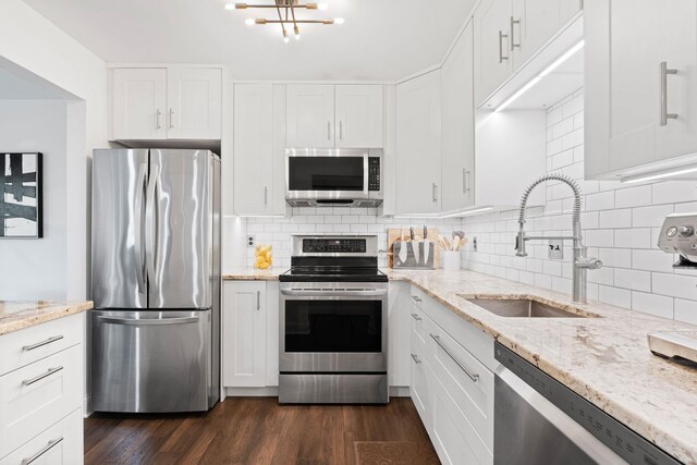 3850 Plymouth Blvd Unit 212, Plymouth, MN 55446 - kitchen with appliances with stainless steel finishes, white cabinets, dark wood finished floors, and backsplash
