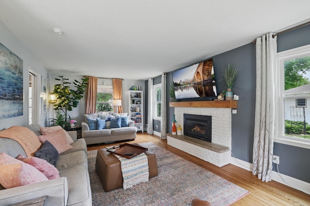 3940 Virginia Ave N, New Hope, MN 55427 - living area featuring wood finished floors, healthy amount of natural light, and a fireplace