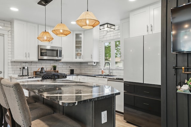 3940 Virginia Ave N, New Hope, MN 55427 - kitchen with stainless steel microwave, white dishwasher, decorative backsplash, a kitchen breakfast bar, and recessed lighting