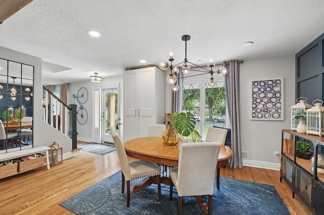 3940 Virginia Ave N, New Hope, MN 55427 - dining area with a chandelier, stairway, a textured ceiling, light wood-style flooring, and recessed lighting