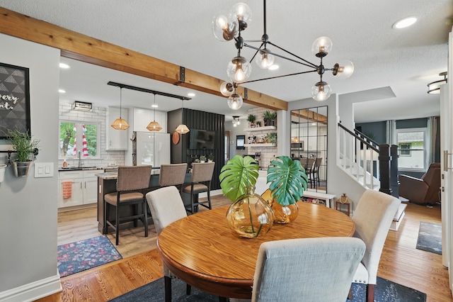 3940 Virginia Ave N, New Hope, MN 55427 - dining room featuring stairs, beam ceiling, light wood-style flooring, recessed lighting, and a textured ceiling