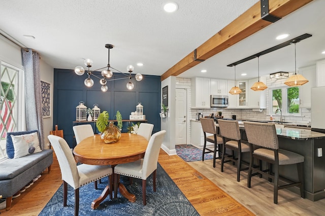 3940 Virginia Ave N, New Hope, MN 55427 - dining area featuring light wood-style floors, a chandelier, a textured ceiling, and recessed lighting
