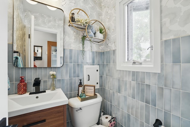 3940 Virginia Ave N, New Hope, MN 55427 - bathroom featuring tile walls, healthy amount of natural light, vanity, and backsplash