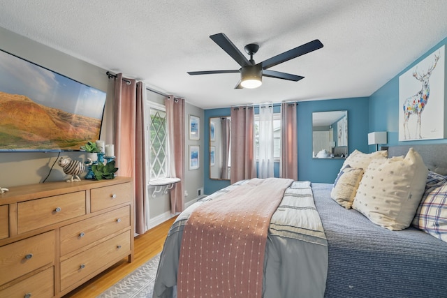 3940 Virginia Ave N, New Hope, MN 55427 - bedroom featuring light wood-style flooring, a textured ceiling, and ceiling fan