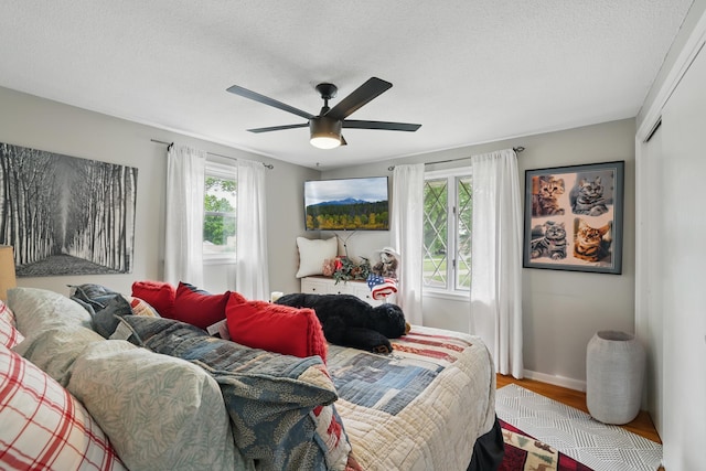 3940 Virginia Ave N, New Hope, MN 55427 - bedroom with wood finished floors, a textured ceiling, and a ceiling fan