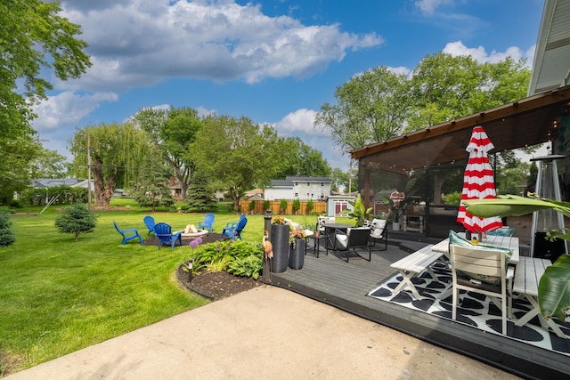 3940 Virginia Ave N, New Hope, MN 55427 - view of patio / terrace with a deck, an outdoor fire pit, outdoor dining area, and a sunroom