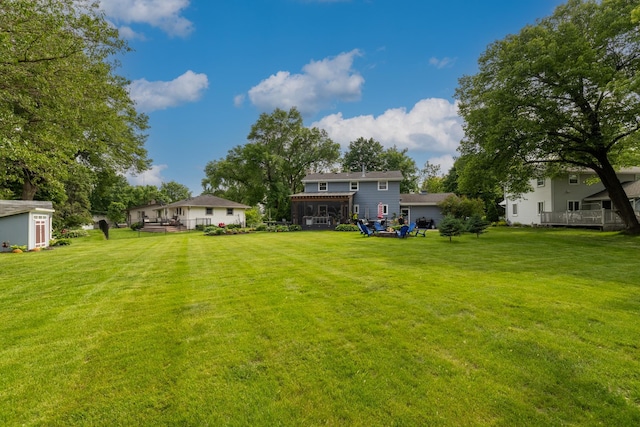 3940 Virginia Ave N, New Hope, MN 55427 - view of green lawn featuring a storage shed and a wooden deck
