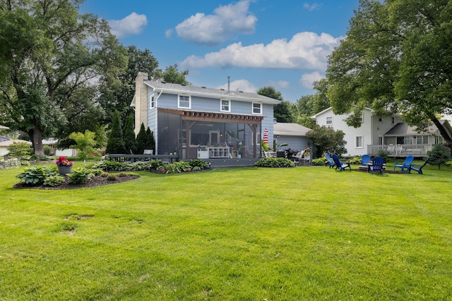 3940 Virginia Ave N, New Hope, MN 55427 - rear view of house featuring a chimney, a sunroom, a yard, and a fire pit