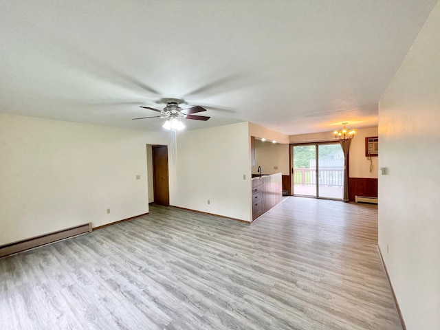 605 13th St, Mountain Lake, MN 56159 - unfurnished living room with light wood finished floors, a chandelier, a ceiling fan, baseboard heating, and a baseboard radiator