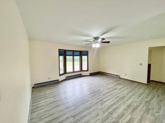 605 13th St, Mountain Lake, MN 56159 - empty room featuring ceiling fan, wood finished floors, baseboards, and baseboard heating