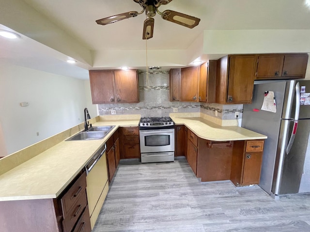 605 13th St, Mountain Lake, MN 56159 - kitchen with appliances with stainless steel finishes, a sink, a peninsula, ceiling fan, and light countertops