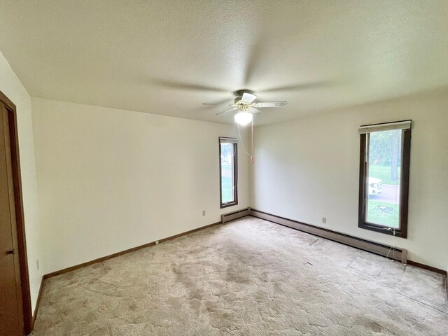 605 13th St, Mountain Lake, MN 56159 - empty room featuring baseboard heating, light carpet, ceiling fan, and baseboards