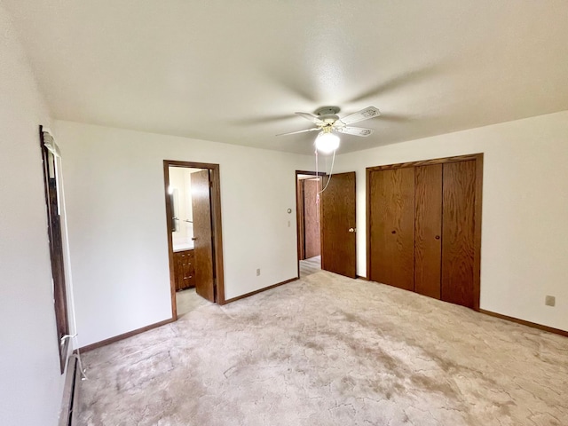 605 13th St, Mountain Lake, MN 56159 - unfurnished bedroom with light carpet, baseboards, ensuite bathroom, and ceiling fan