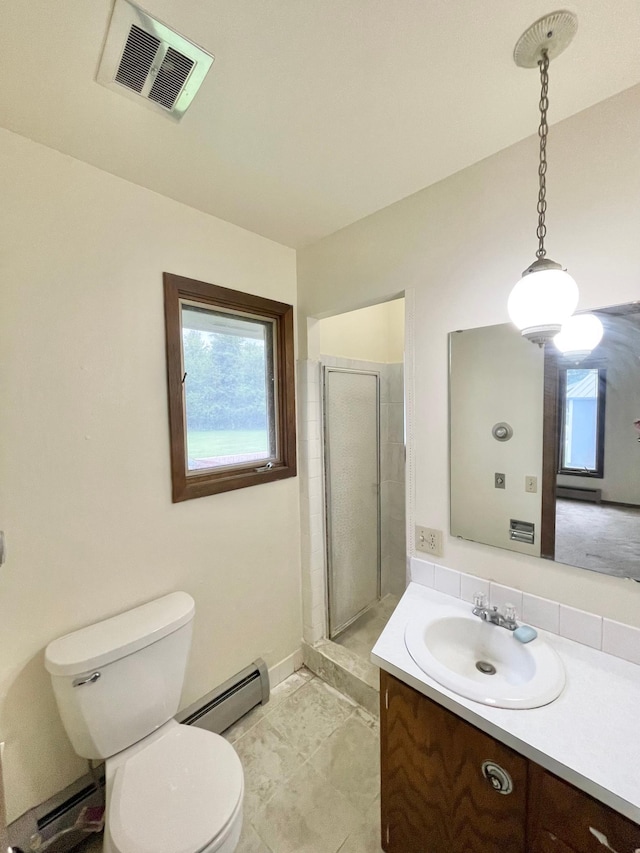 605 13th St, Mountain Lake, MN 56159 - full bath featuring a baseboard heating unit, vanity, toilet, and plenty of natural light