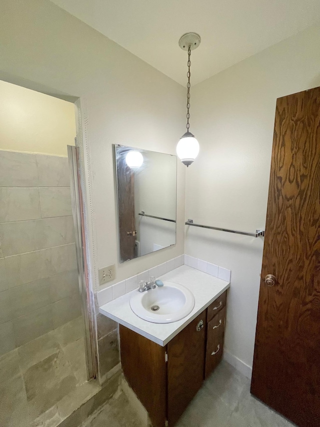 605 13th St, Mountain Lake, MN 56159 - bathroom with vanity and a tile shower