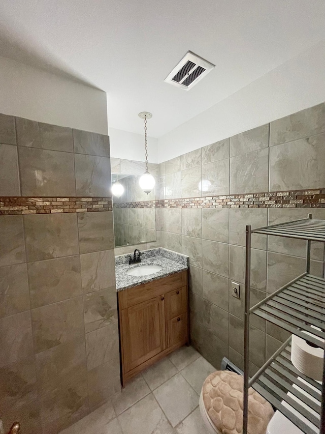 605 13th St, Mountain Lake, MN 56159 - bathroom featuring tile walls, vanity, and tile patterned flooring