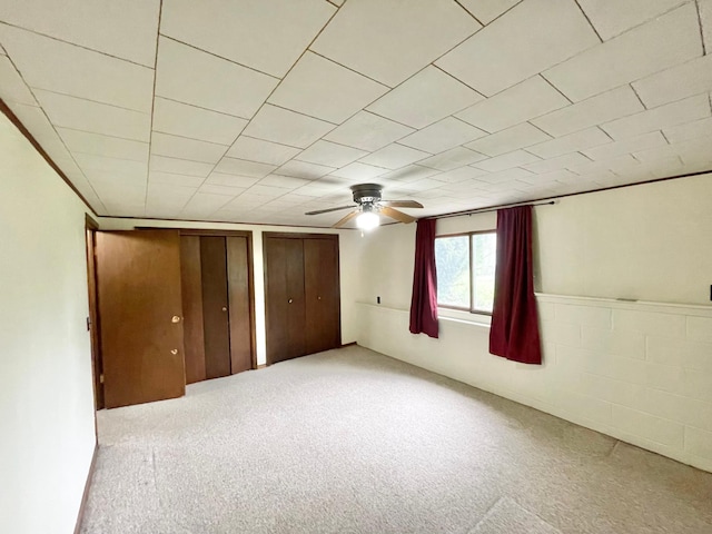 605 13th St, Mountain Lake, MN 56159 - unfurnished bedroom with carpet floors, multiple closets, and a ceiling fan