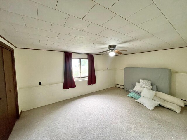 605 13th St, Mountain Lake, MN 56159 - unfurnished room featuring carpet, a baseboard radiator, and a ceiling fan