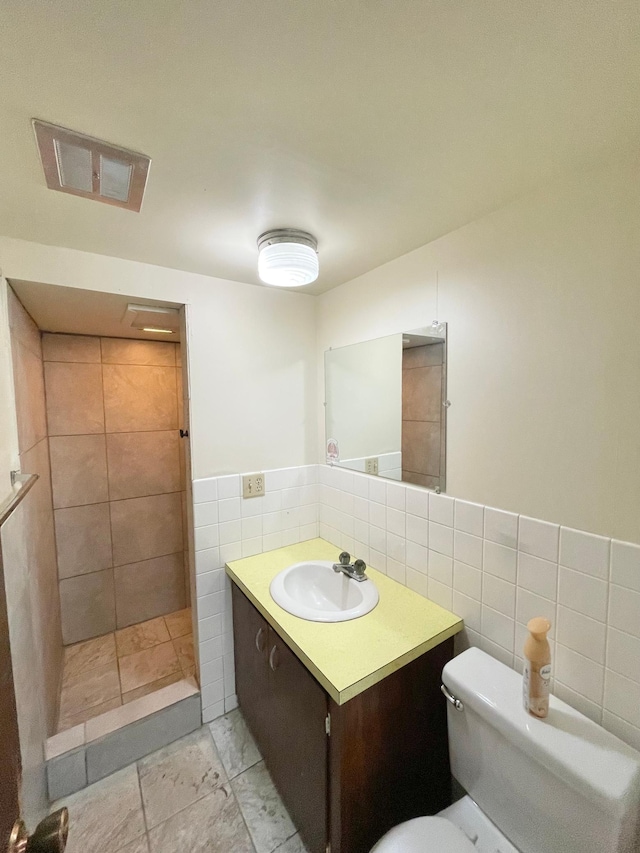 605 13th St, Mountain Lake, MN 56159 - full bath with tile walls, vanity, toilet, and a tile shower
