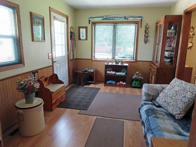 1223 Elizabeth Ave N, Thief River Falls, MN 56701 - living room featuring a wainscoted wall, wood walls, and wood finished floors