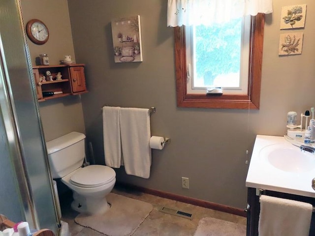 1223 Elizabeth Ave N, Thief River Falls, MN 56701 - bathroom featuring vanity, toilet, an enclosed shower, and tile patterned floors