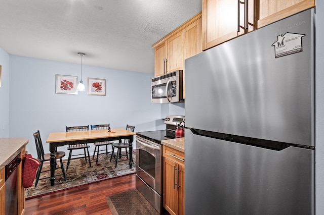 1901 Emerson Ave S Unit 303, Minneapolis, MN 55403 - kitchen featuring stainless steel appliances, dark wood-style flooring, light countertops, light brown cabinets, and pendant lighting