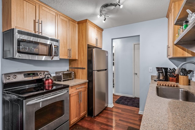 1901 Emerson Ave S Unit 303, Minneapolis, MN 55403 - kitchen featuring stainless steel appliances, dark wood-type flooring, light countertops, and a textured ceiling