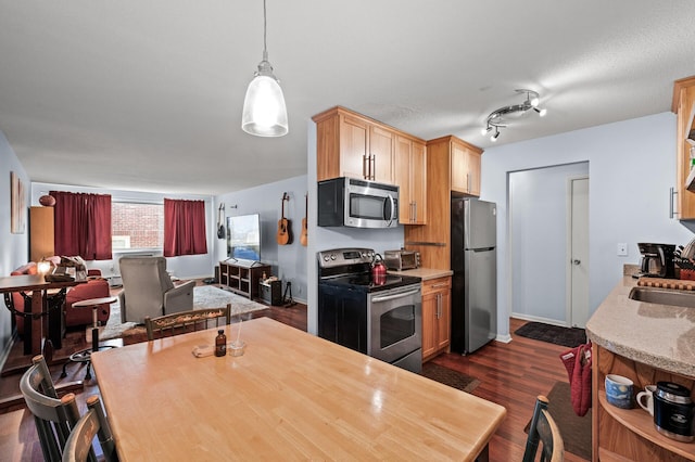1901 Emerson Ave S Unit 303, Minneapolis, MN 55403 - kitchen featuring stainless steel appliances, dark wood finished floors, open floor plan, light brown cabinetry, and pendant lighting