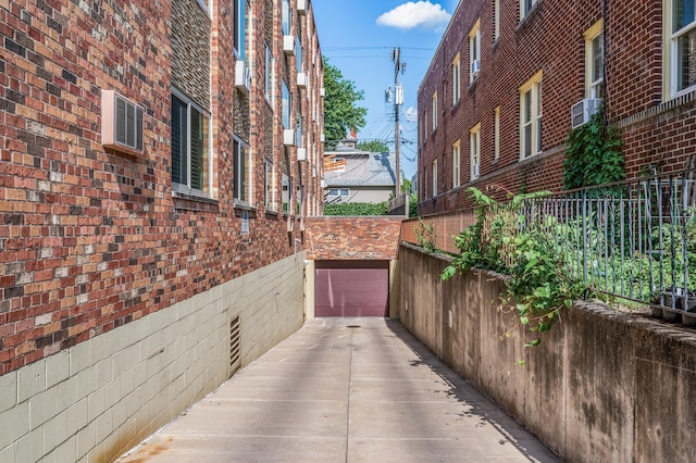 1901 Emerson Ave S Unit 303, Minneapolis, MN 55403 - view of patio featuring concrete driveway and a garage